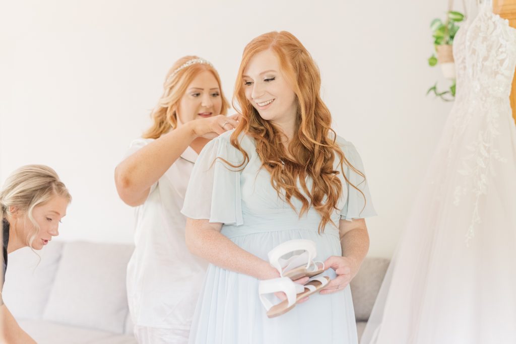 aiden laurette photography | two red headed women dressed in white and light blue having a conversation