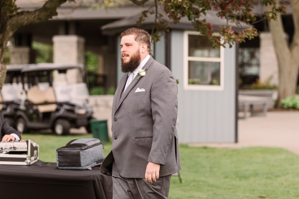 aiden laurette photography | bearded man stands in front of table
