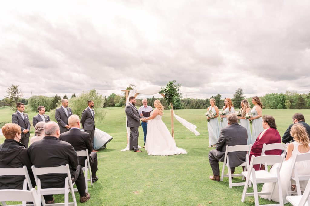 aiden laurette photography | wedding ceremony with guests seated in chairs facing bride and groom