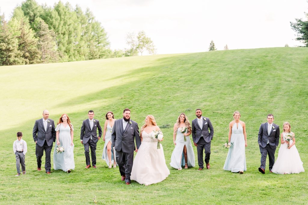 aiden laurette photography | wedding party poses in front of green hill