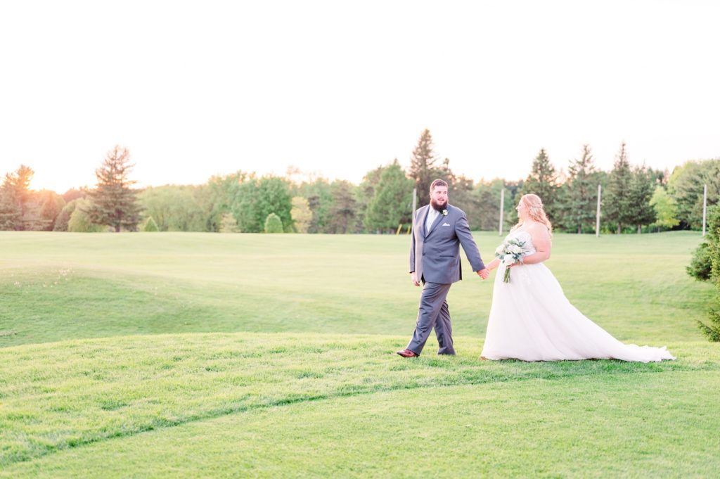 aiden laurette photography | bride and groom walking looking at eachother smiling