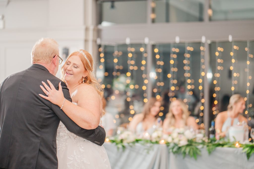 aiden laurette photography | bride an man dancing while bridesmaids look on in  background