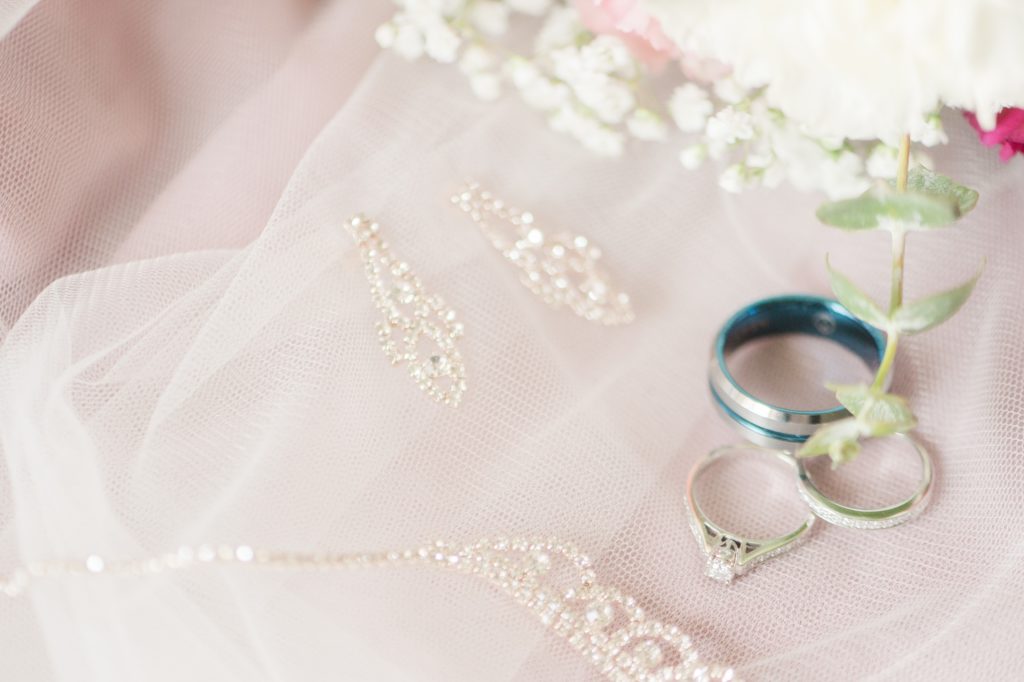 Aiden Laurette Photography | close up photo of wedding rings on white veil