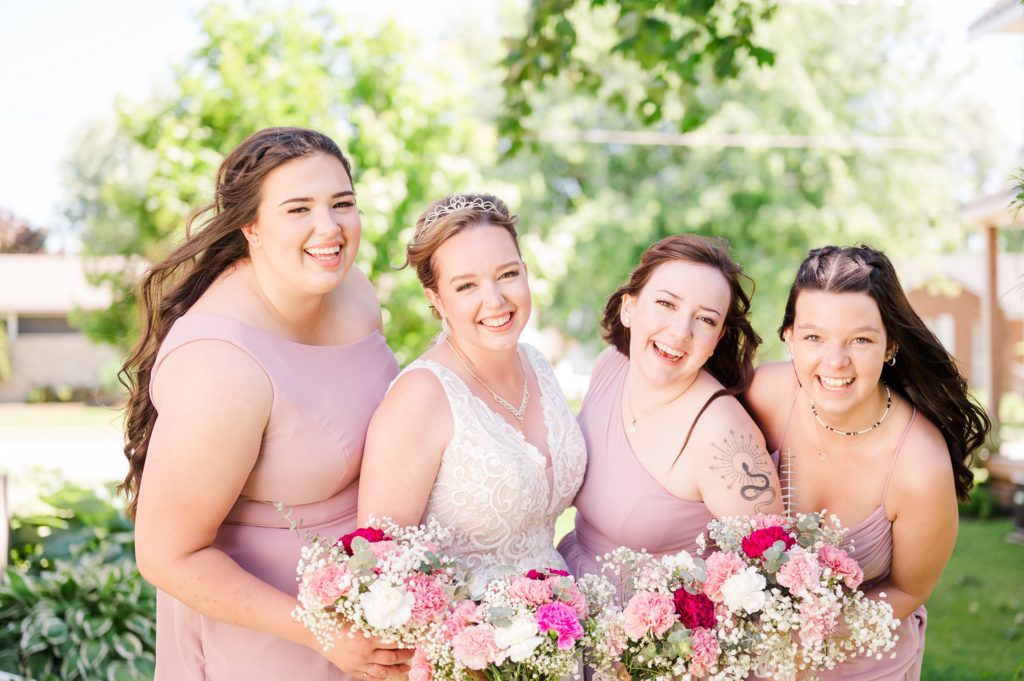 Aiden Laurette Photography | bride poses with bridesmaids