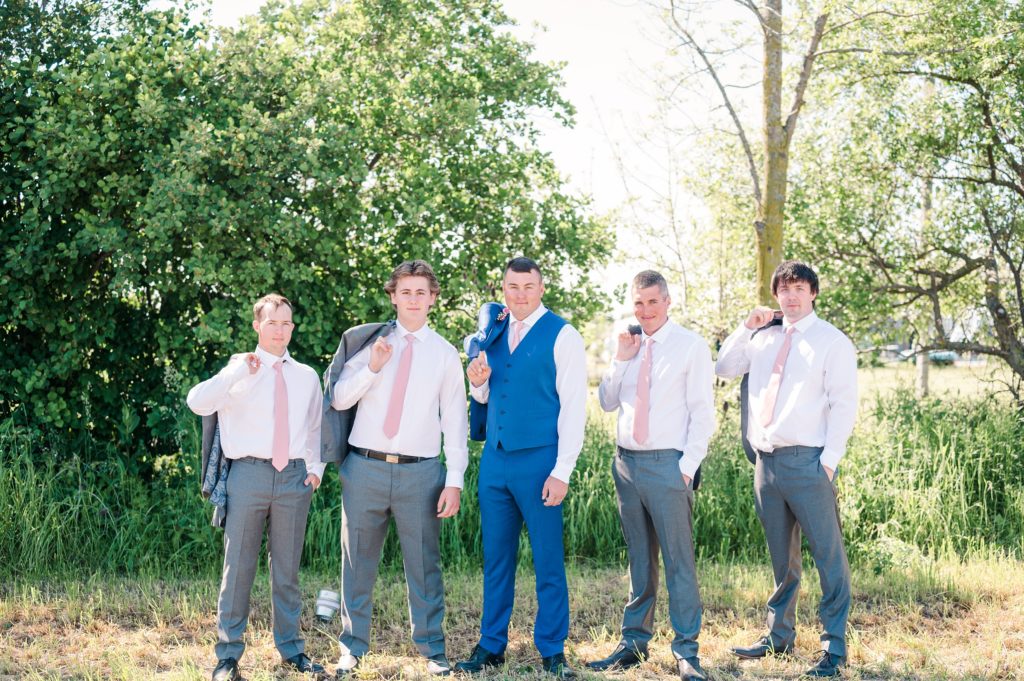 Aiden Laurette Photography | groom and groomsmen pose in front of trees