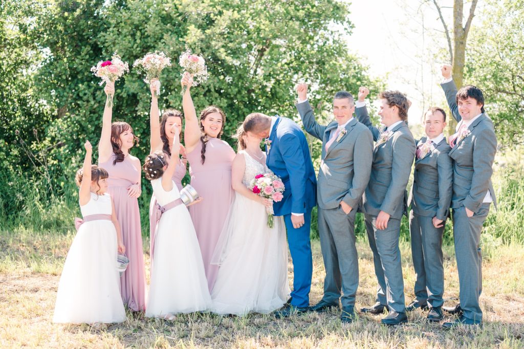 Aiden Laurette Photography | bride and groom kiss as bridal party cheers