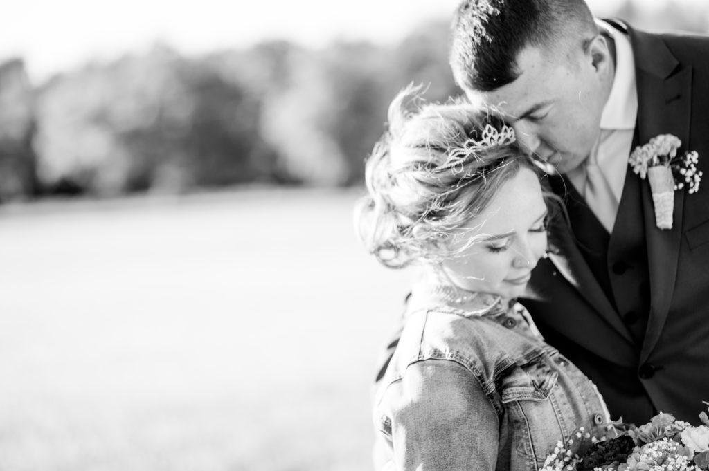 Aiden Laurette Photography | close up black and white photo of bride and groom in field