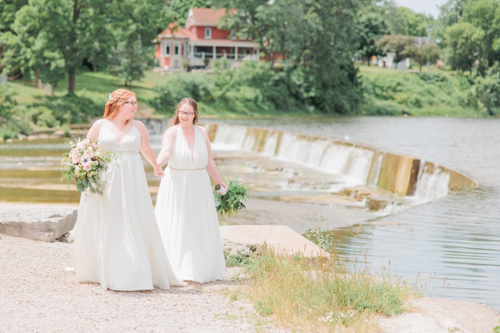 Aiden Laurette Photography | brides pose in front of creek and greenery