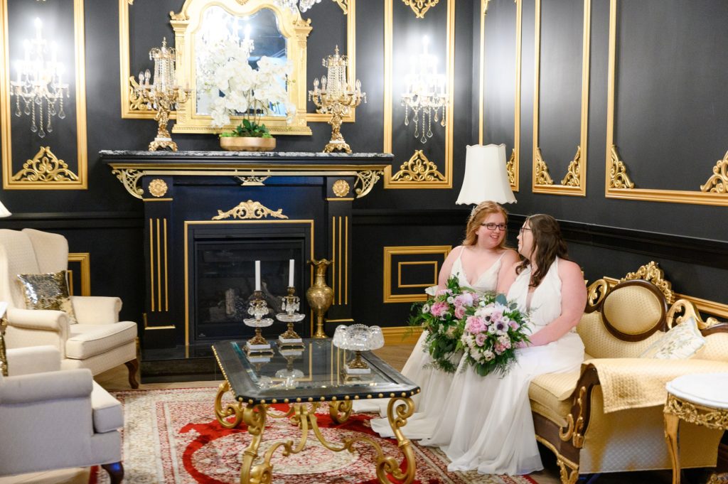 Aiden Laurette Photography | brides sit on couch in lounge