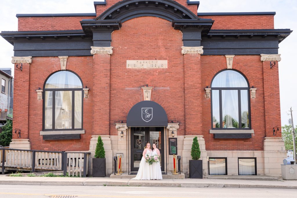 Aiden Laurette Photography | brides pose in front of red brick building