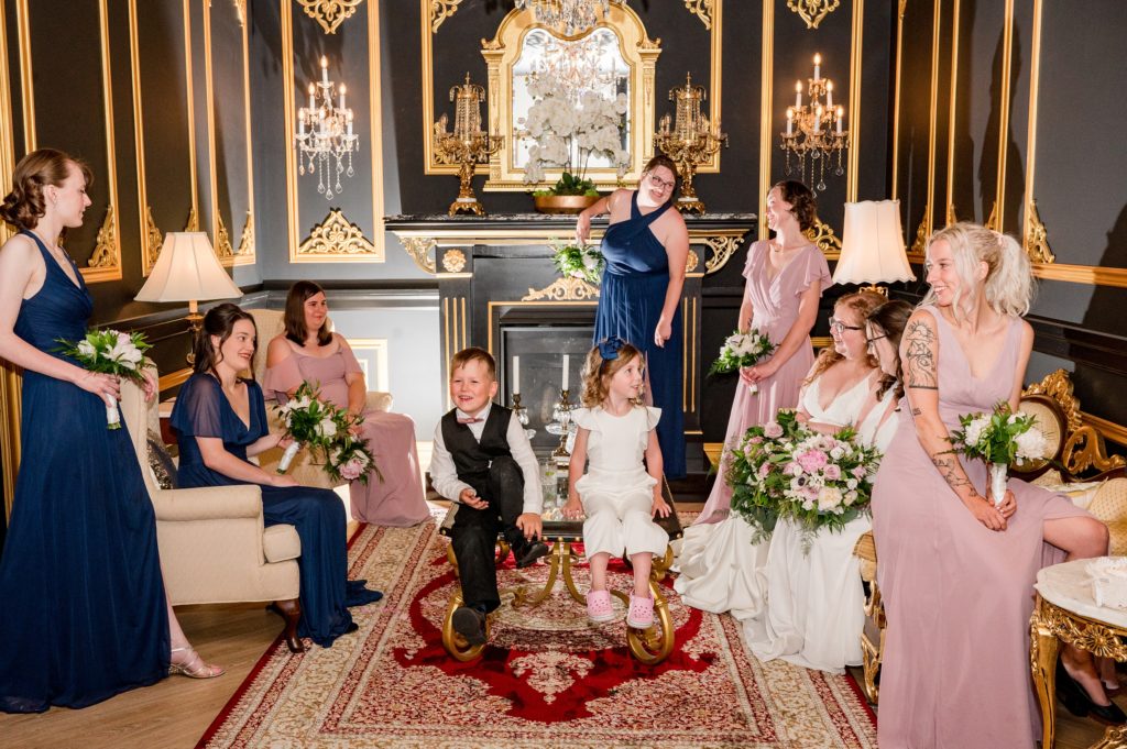 Aiden Laurette Photography | brides and bridal party sit in lounge