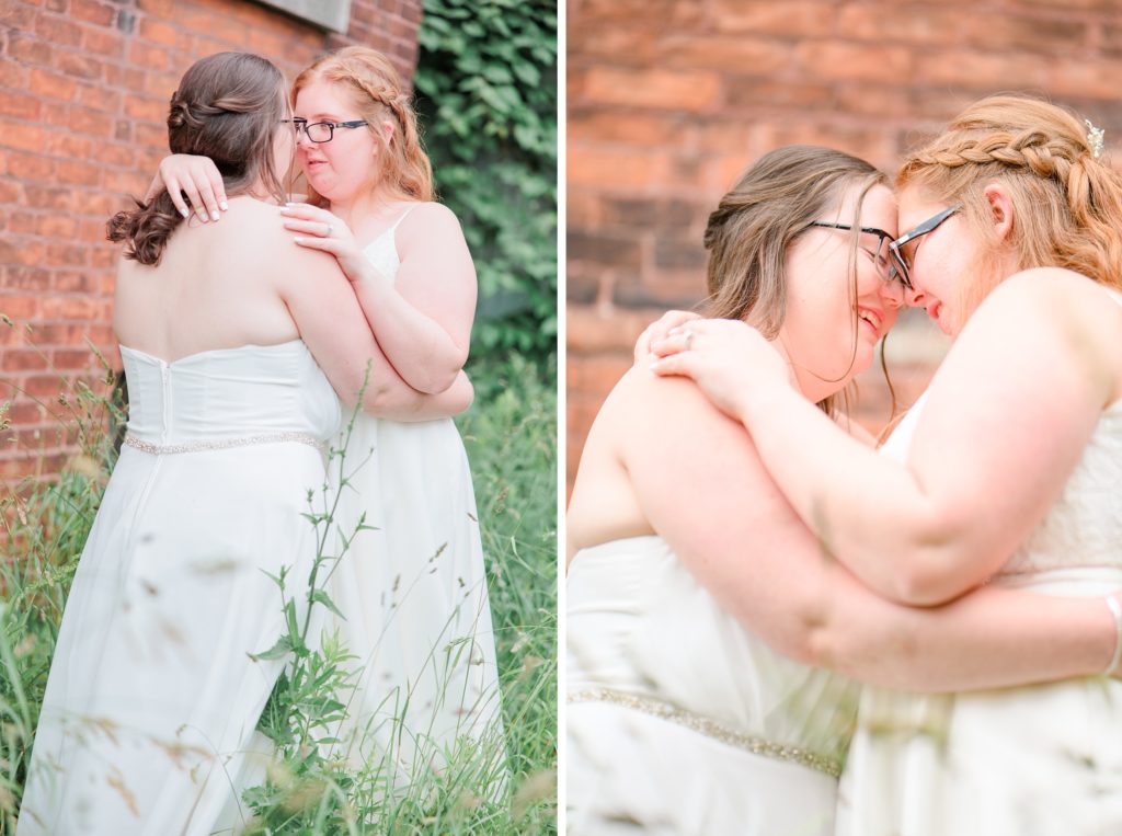 Aiden Laurette Photography | brides posing in greenery in front of brick wall