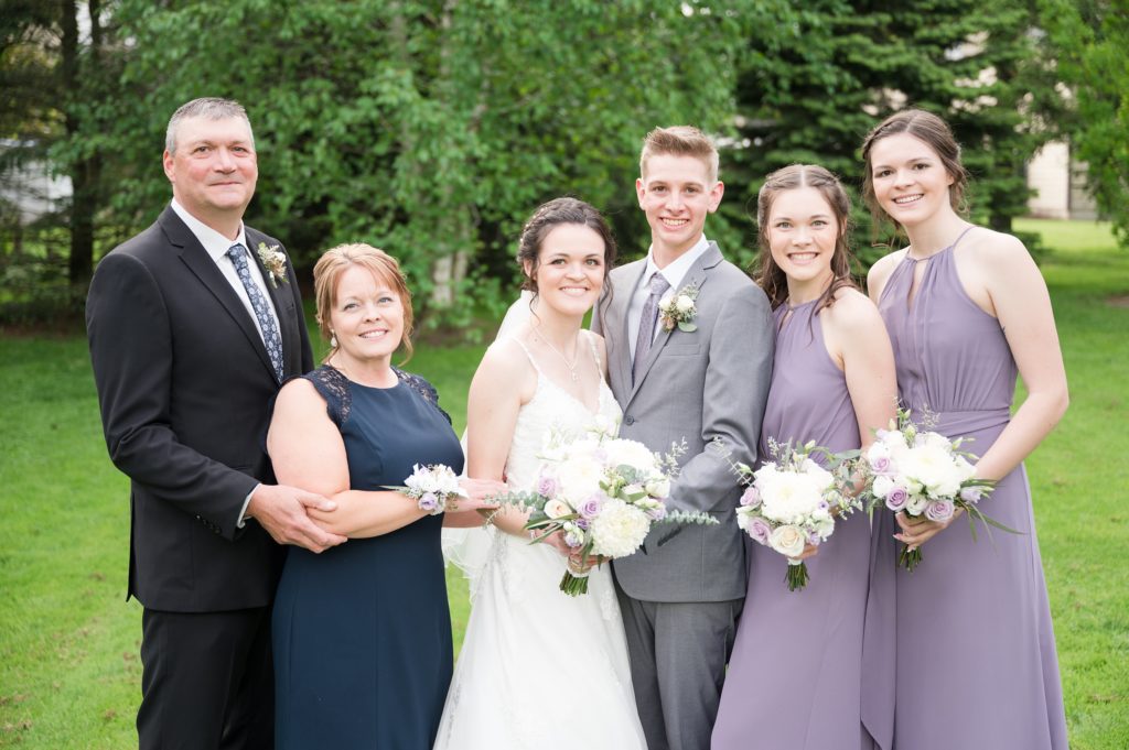 Aiden Laurette Photography | bride and groom pose in the middle of bridesmaids and man and woman