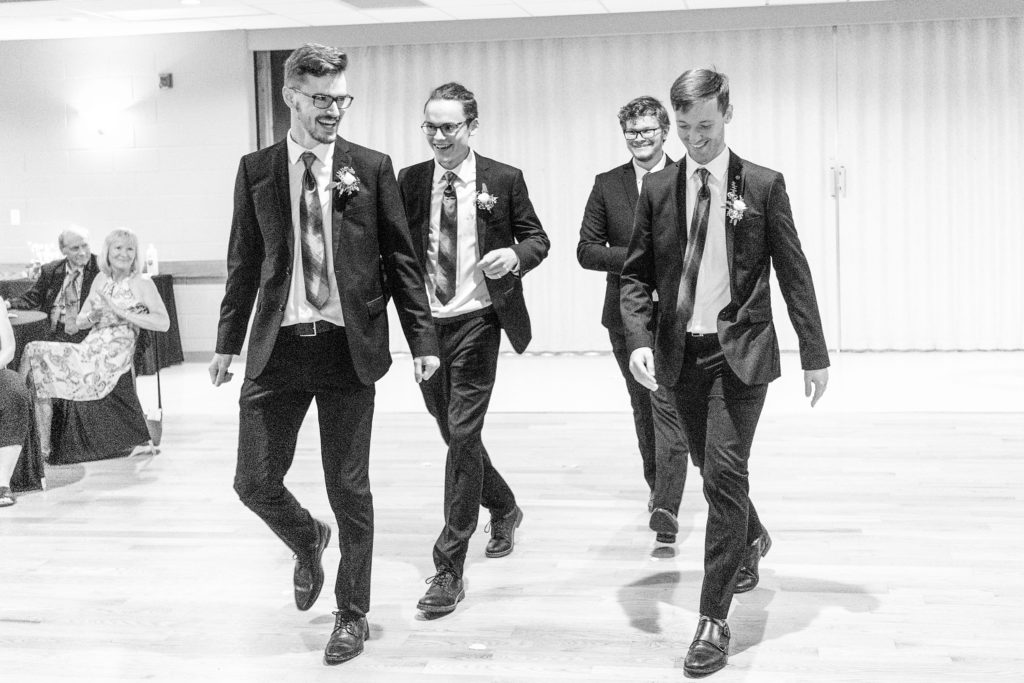 Aiden Laurette Photography | black and white photo of four men in formal wear walking