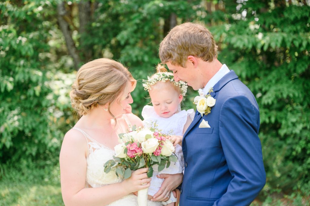 Aiden Laurette Photography | bride and groom pose with baby in white dress