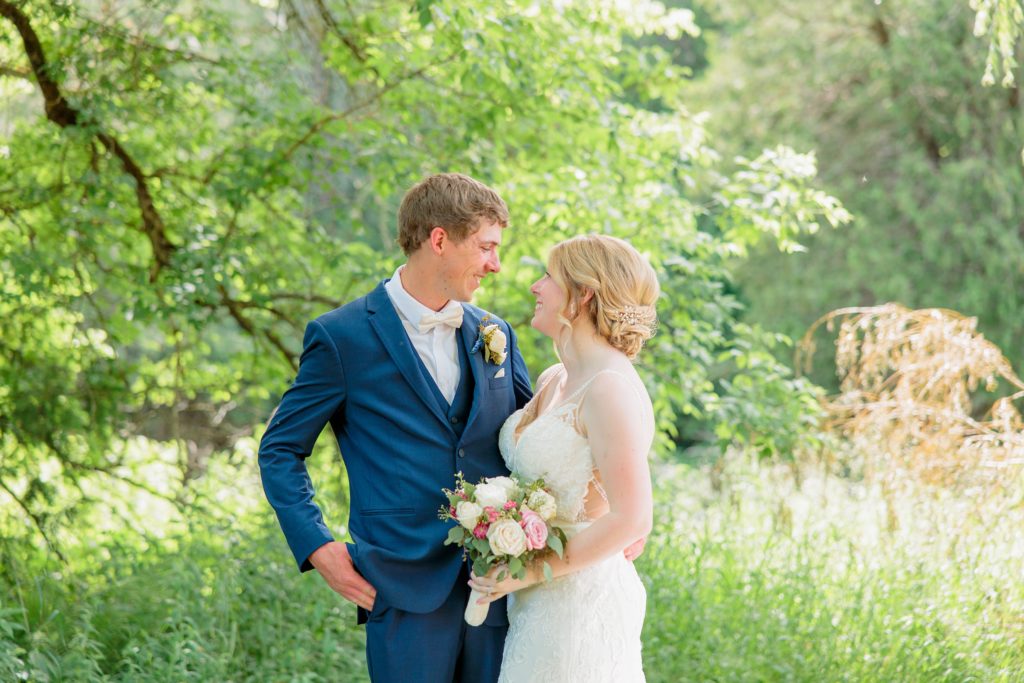 Aiden Laurette Photography | bride and groom look at eachother and smile