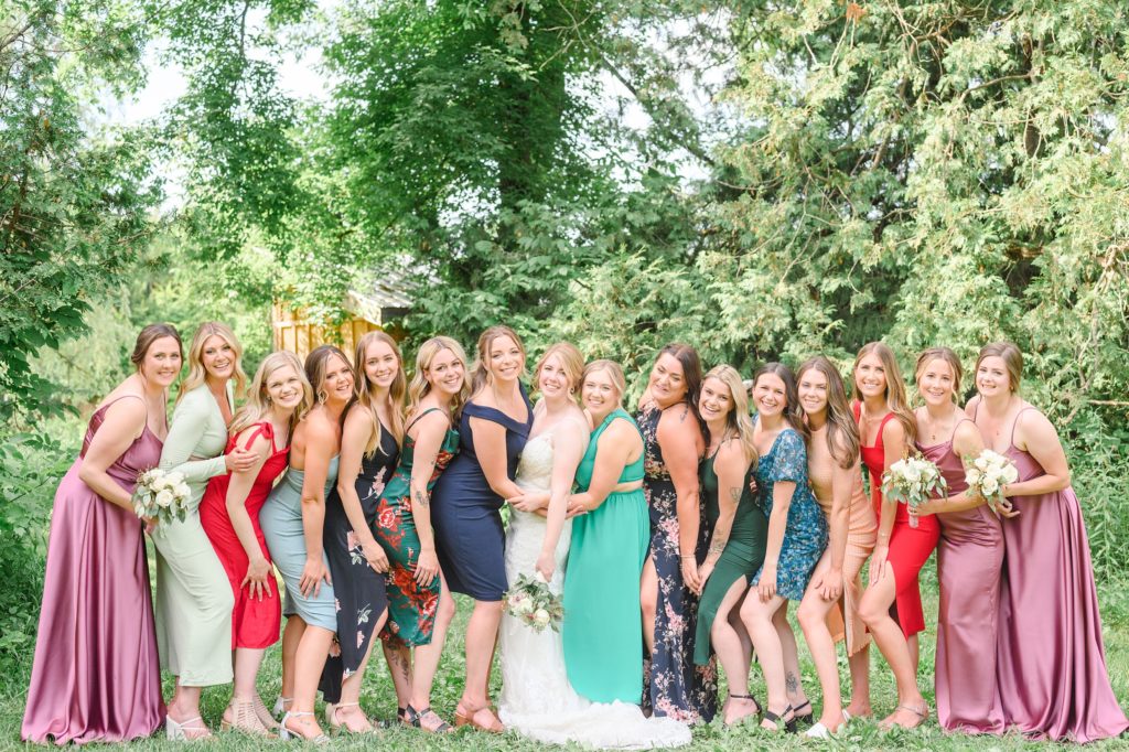 Aiden Laurette Photography | group of women pose and smile in front of trees