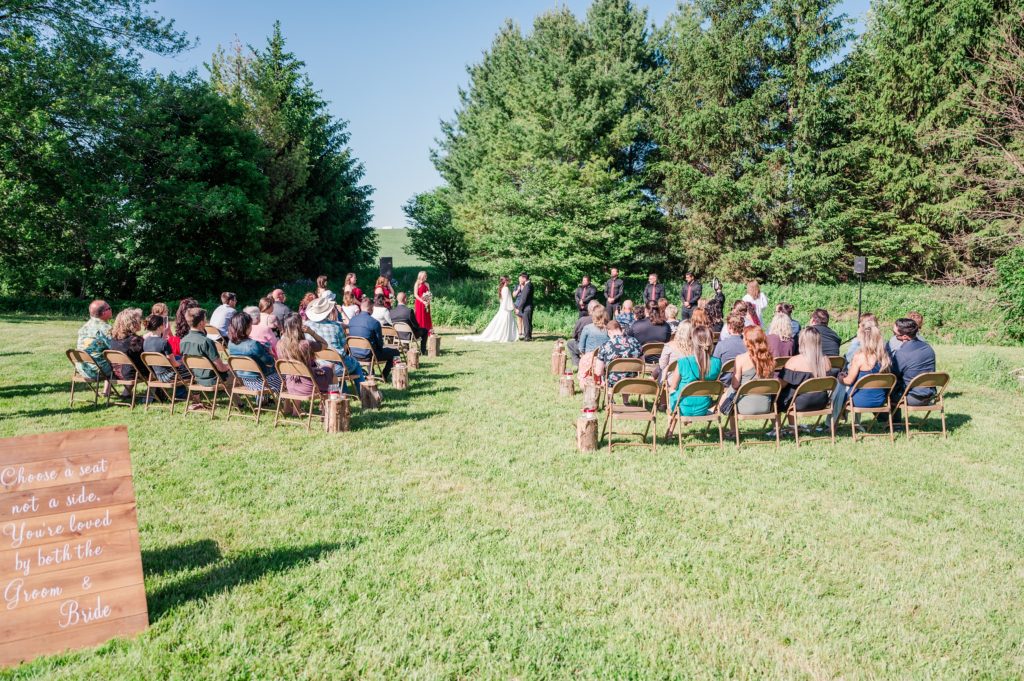 Aiden Laurette Photography | wedding guests look on as bride and groom hold hands