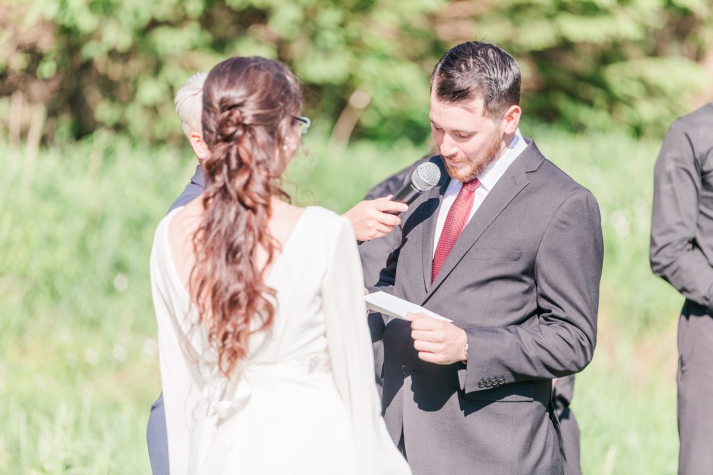Aiden Laurette Photography | groom speaks into microphone while bride watches