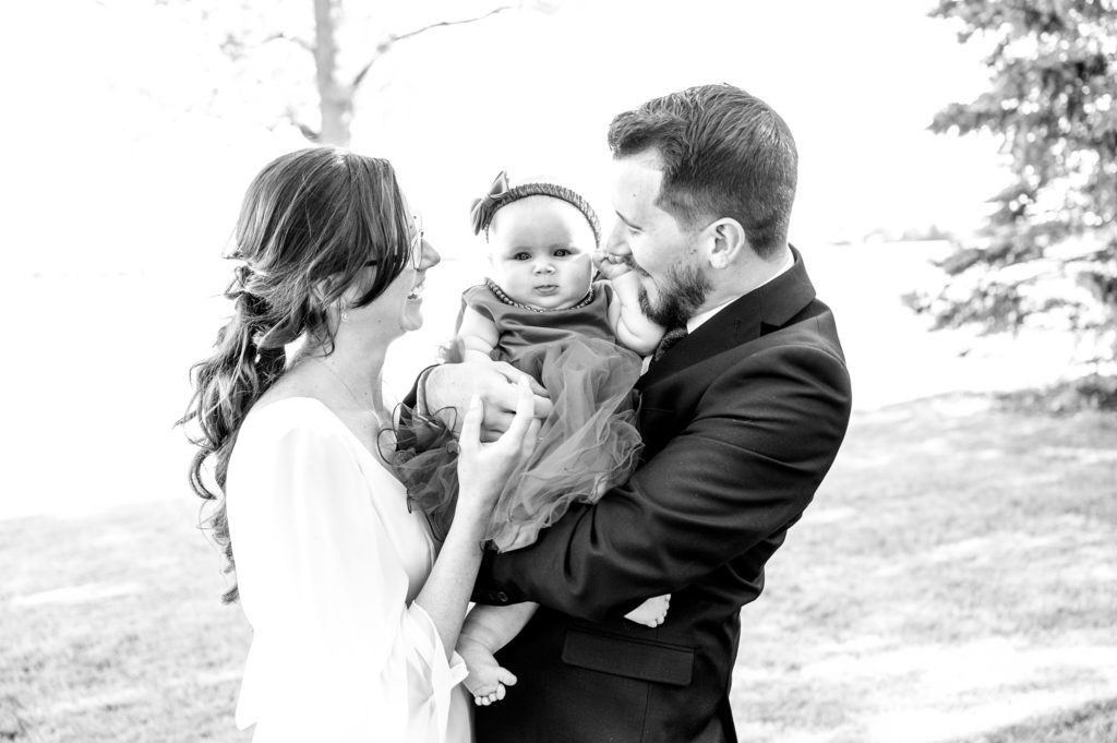Aiden Laurette Photography | man and woman hold infant between them