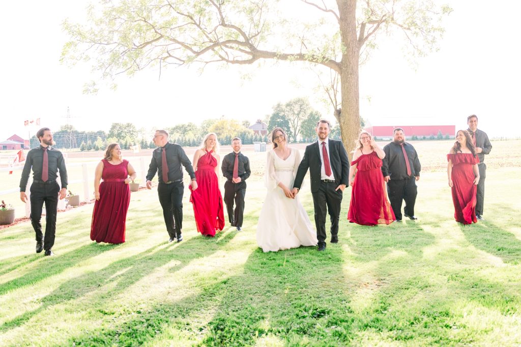 Aiden Laurette Photography | bride and groom walk with wedding party