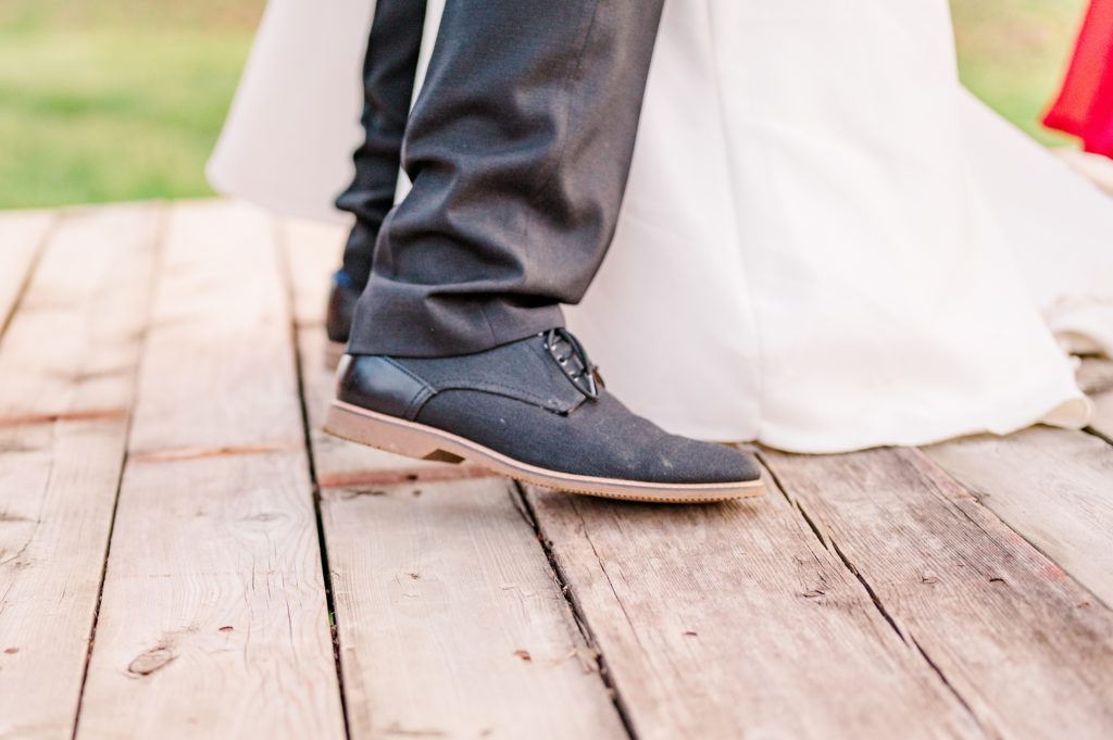 Aiden Laurette Photography | close up photo of bride and grooms feet dancing