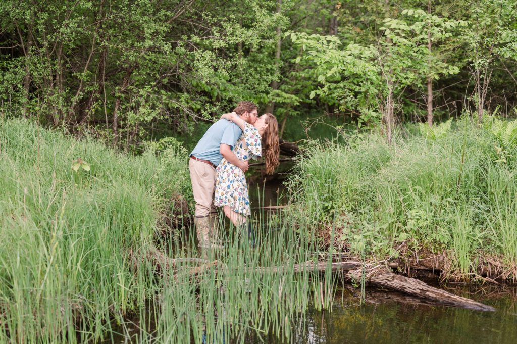 Aiden Laurette Photography | man and woman standing in creek kissing