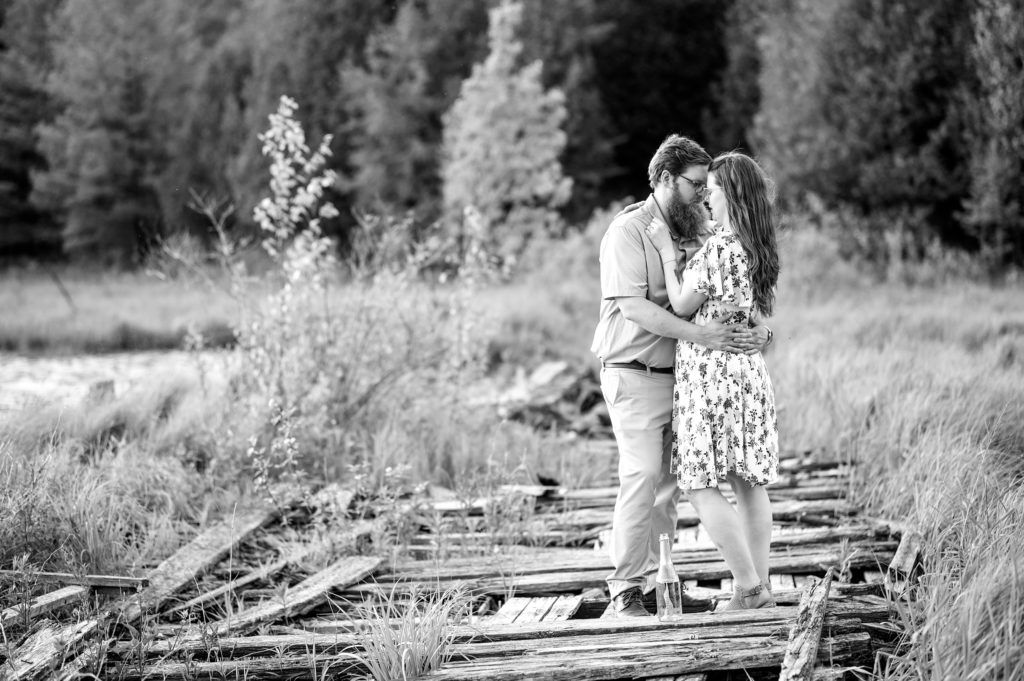 Aiden Laurette Photography | black and white photo of man and woman embracing in field