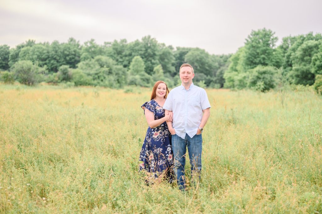 Aiden Laurette Photography | man and woman stand in green field