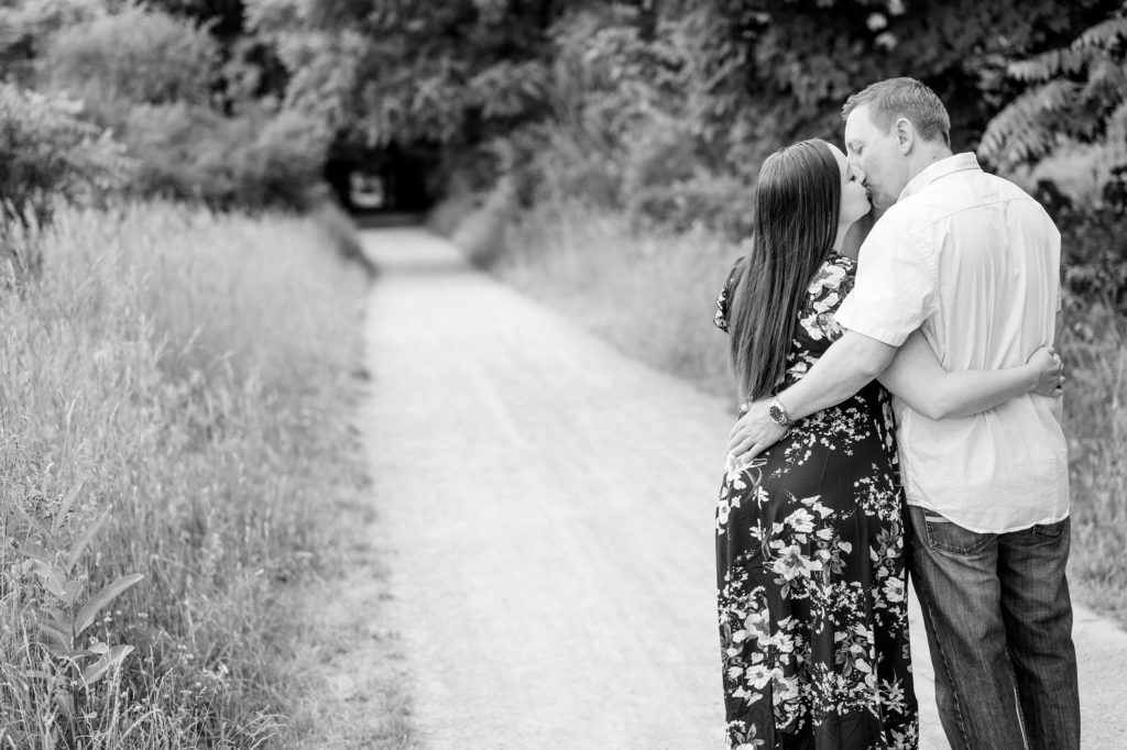 Aiden Laurette Photography | man and woman stand kissing on trail