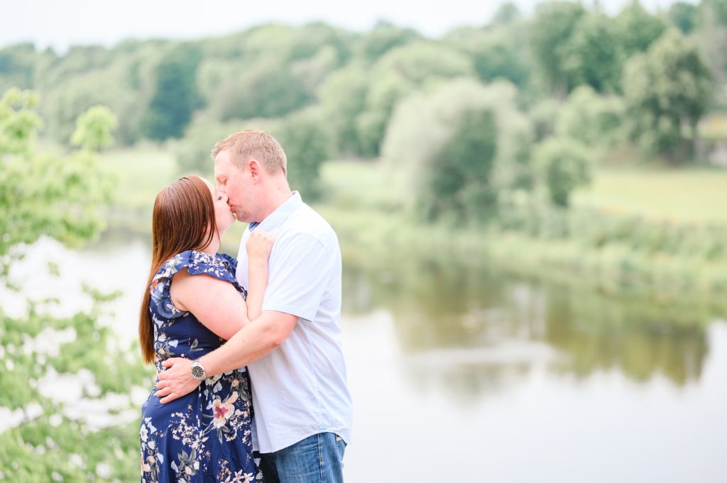 Aiden Laurette Photography | man and woman kiss in front of river