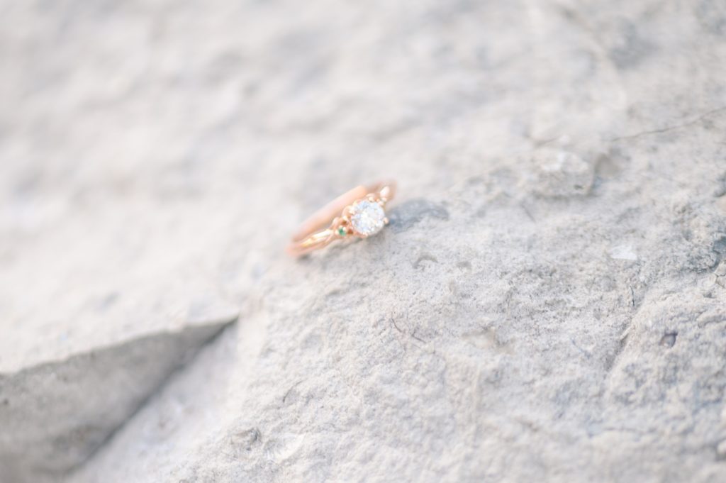Aiden Laurette Photography | close up photo of engagement ring on rock