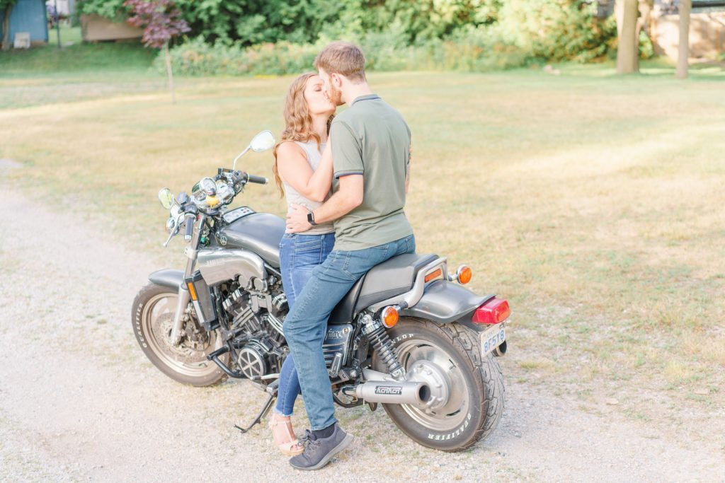 Aiden Laurette Photography | man and woman sit on motorcycle and kiss