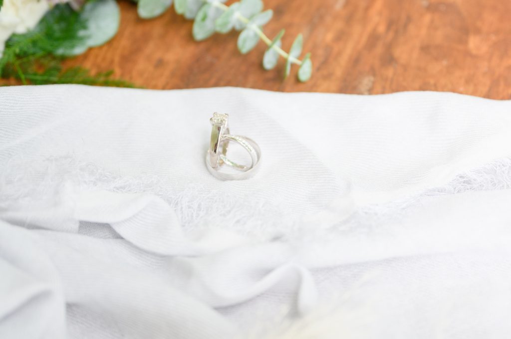 Aiden Laurette Photography | close up photo of wedding rings on dress train