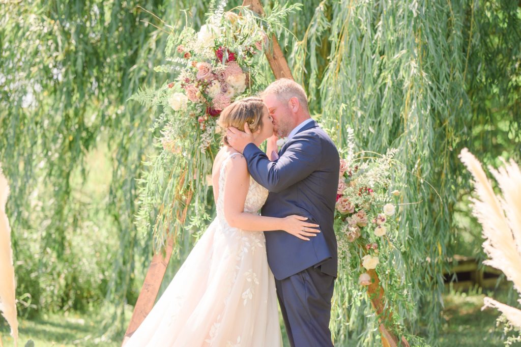 Aiden Laurette Photography | bride and groom kiss at altar