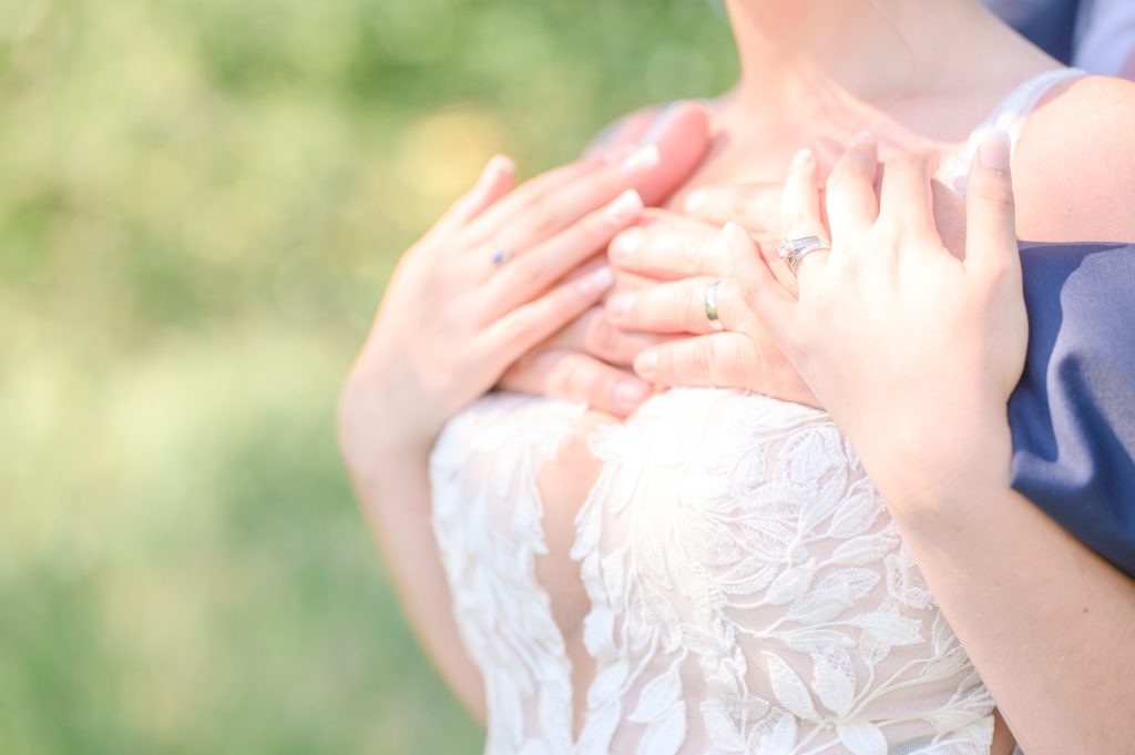 Aiden Laurette Photography | close up photo of bride and grooms hands in an embrace