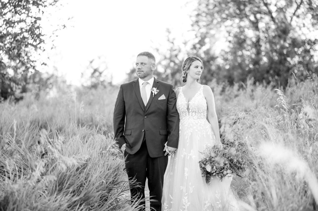 Aiden Laurette Photography | bride and groom stand in front of willow trees in field