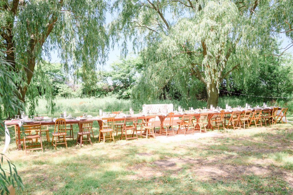 Aiden Laurette Photography | table and chairs on greenery under willow trees