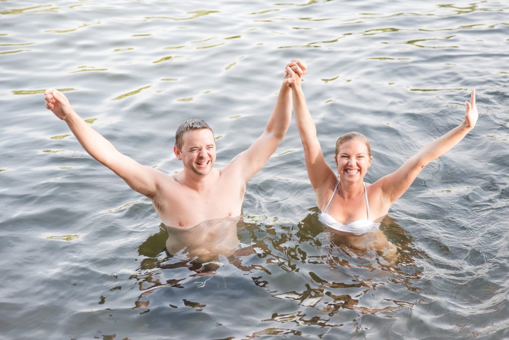 Aiden Laurette Photography | man and woman hold hands in water