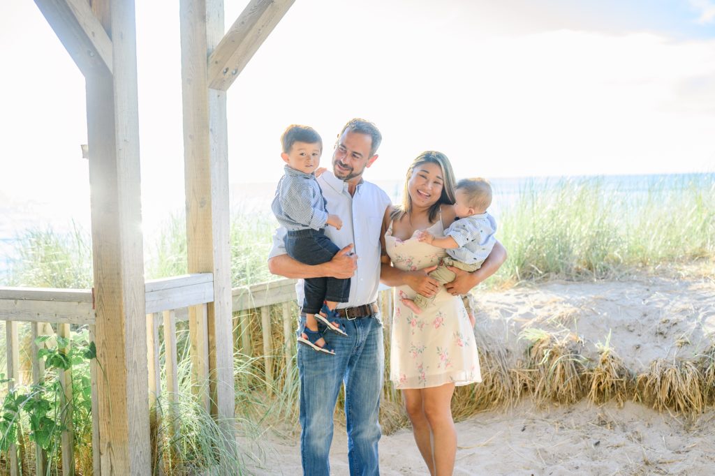 Aiden Laurette Photography | man and woman hold their two sons on the beach