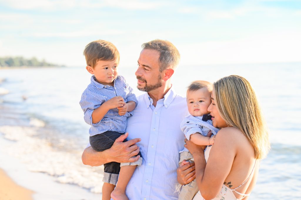 Aiden Laurette Photography | engaged couple stand with toddler and infant on beach