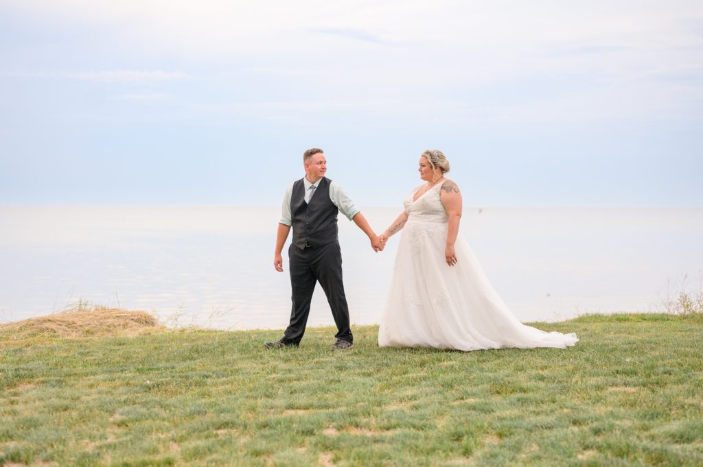 Aiden Laurette Photography | Bride and groom walk on beach