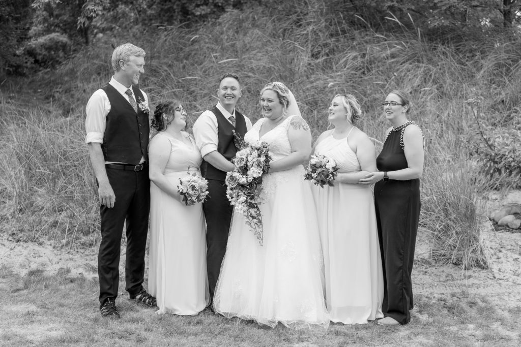 Aiden Laurette Photography | black and white photo of wedding party on beach