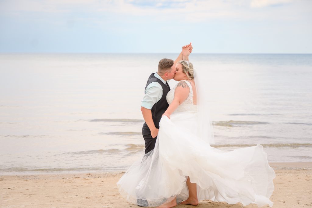 Aiden Laurette Photography | bride and groom on beach