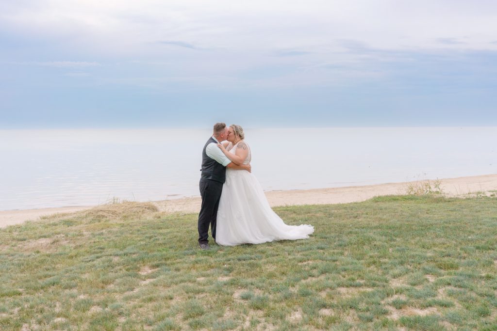 Aiden Laurette Photography | bride and groom kiss on beach