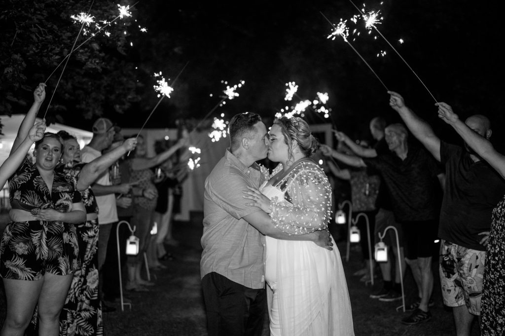 Aiden Laurette Photography | bride and groom kiss under sparklers