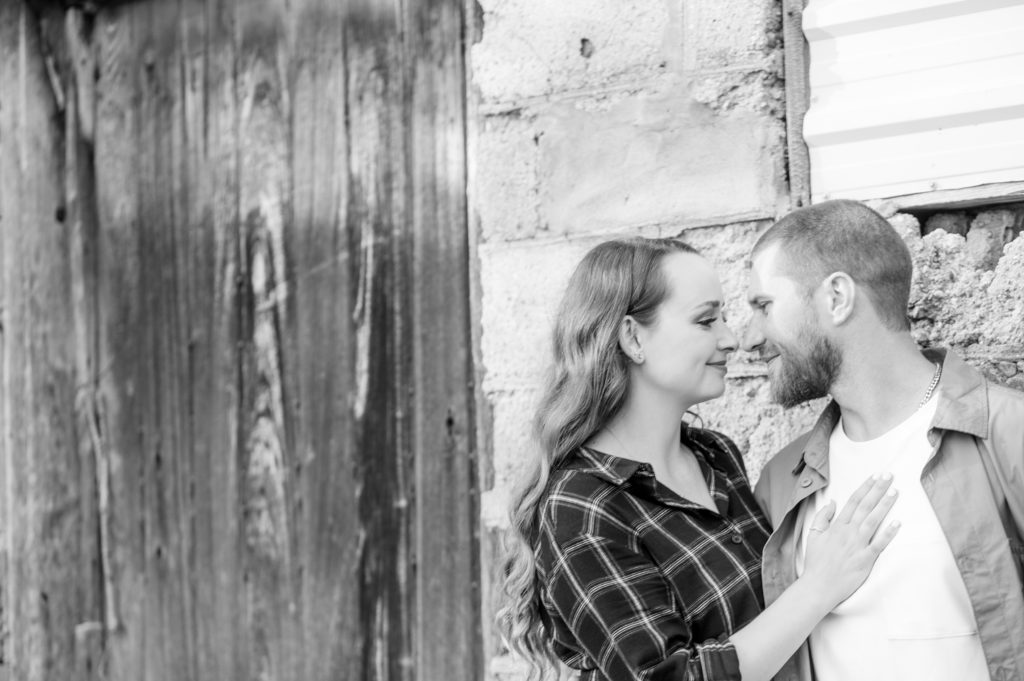 Aiden Laurette Photography | man and woman hug in front of brick structure
