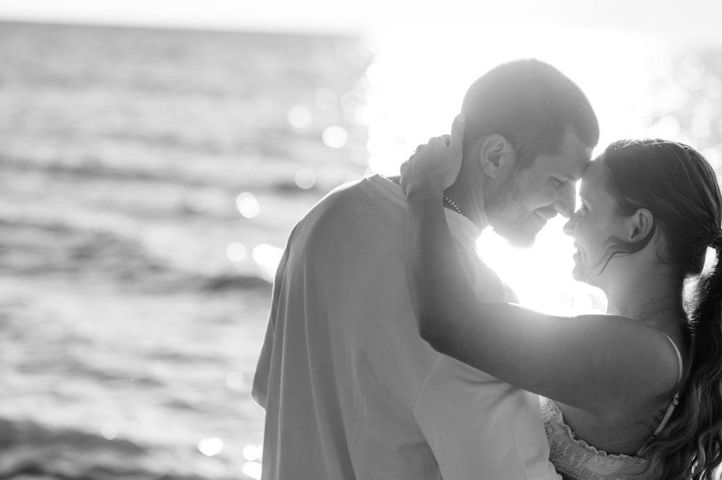 Aiden Laurette Photography | black and white photograph of man and woman embracing on beach