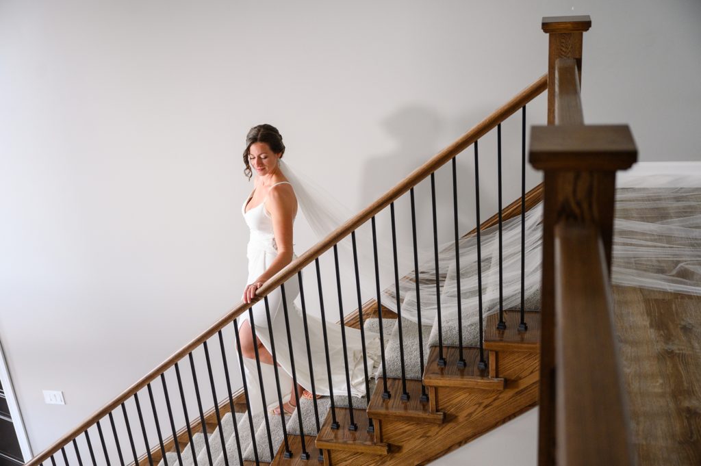 Aiden Laurette Photography | bride walks down staircase