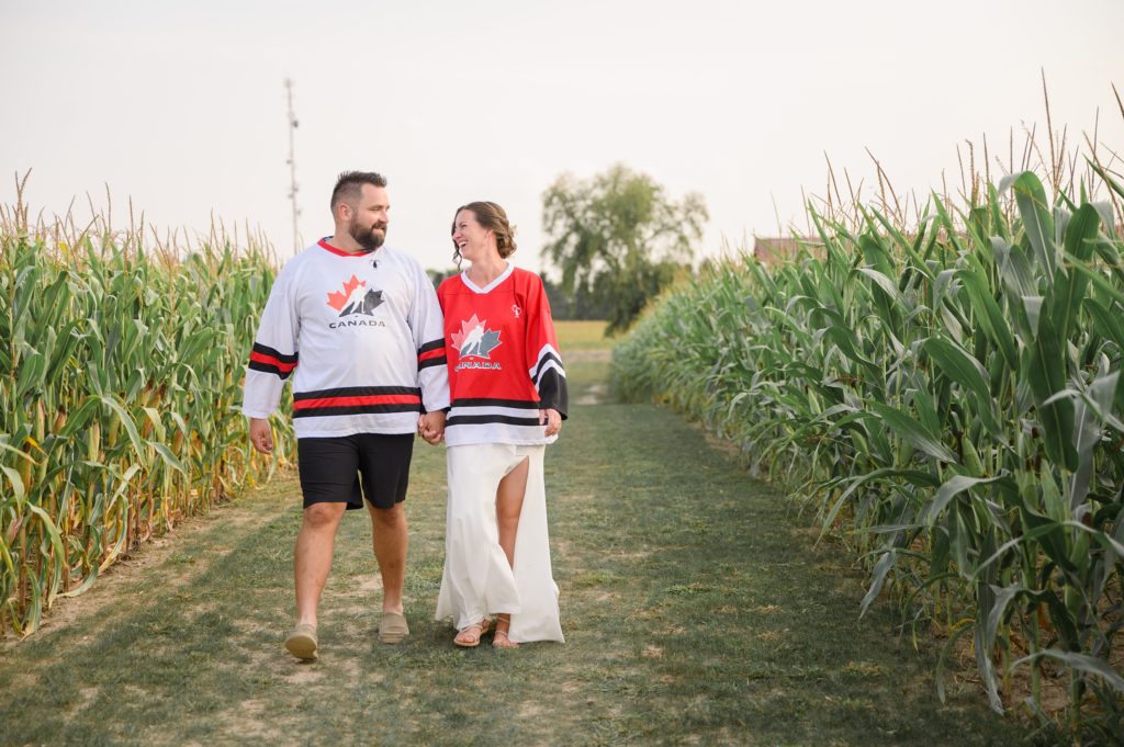 Aiden Laurette Photography | bride and groom walk in cornfield